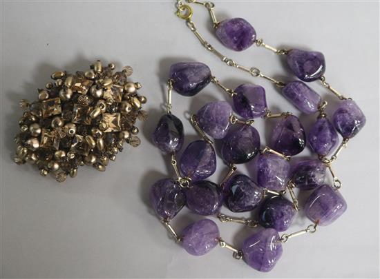 An amethyst pebble bead necklace and a Christian Dior brooch signed and numbered 1960, with original box and pouch.